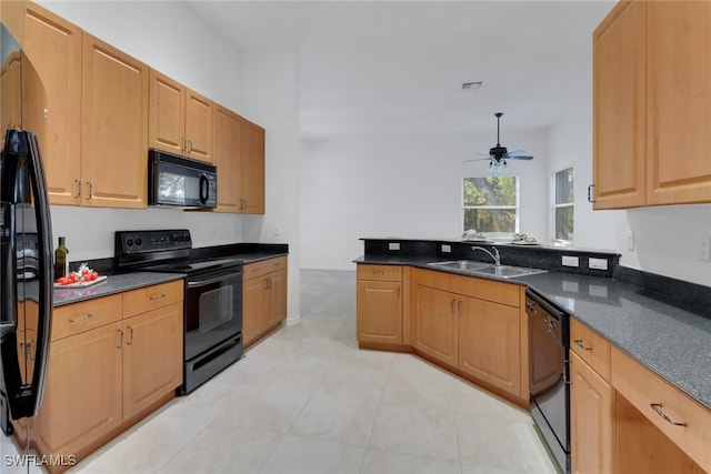 kitchen with kitchen peninsula, dark stone counters, ceiling fan, sink, and black appliances