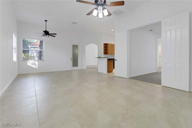 unfurnished living room with ceiling fan