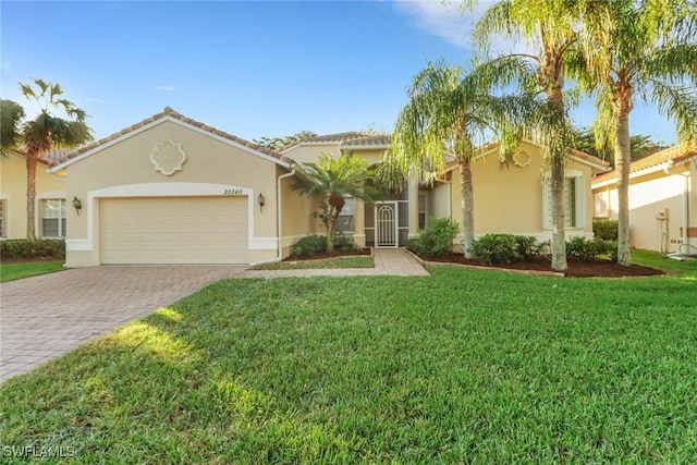 mediterranean / spanish-style home with a front yard and a garage