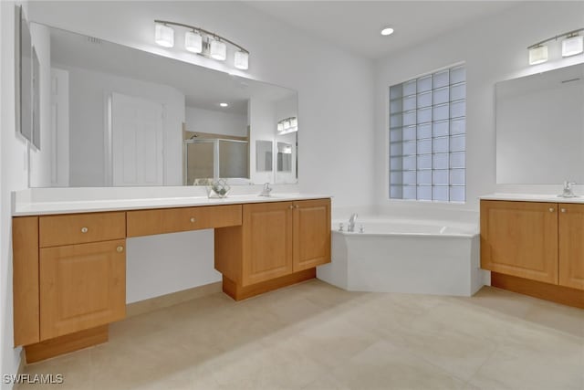 bathroom featuring vanity and shower with separate bathtub