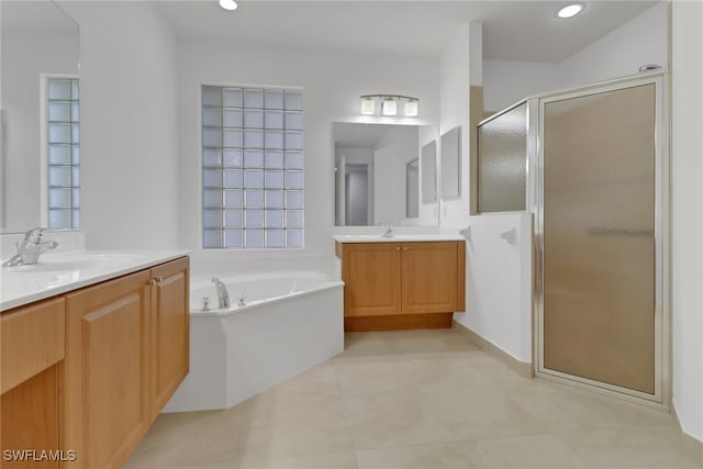 bathroom featuring shower with separate bathtub and vanity