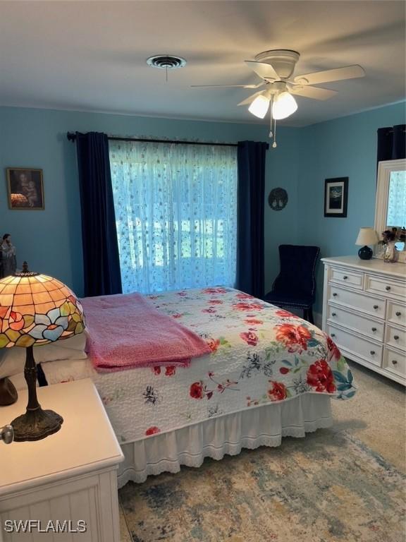 carpeted bedroom with ceiling fan