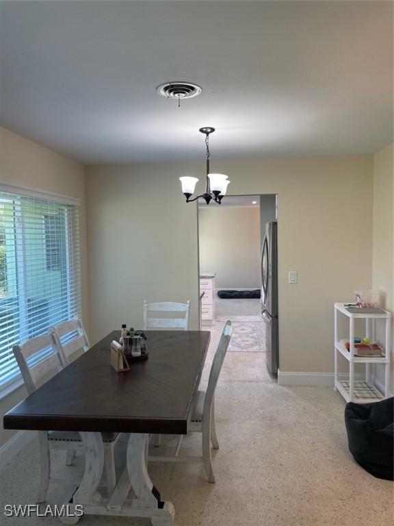 dining space featuring a notable chandelier