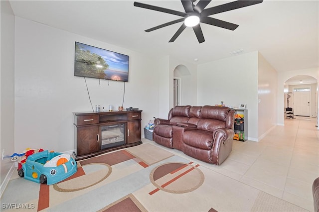 living room with ceiling fan and light tile patterned flooring