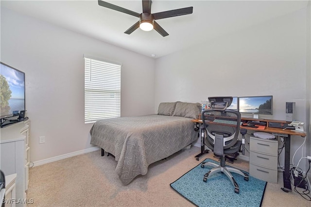 bedroom featuring light colored carpet and ceiling fan