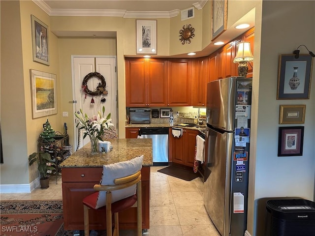 kitchen with a breakfast bar, stainless steel appliances, ornamental molding, and stone countertops