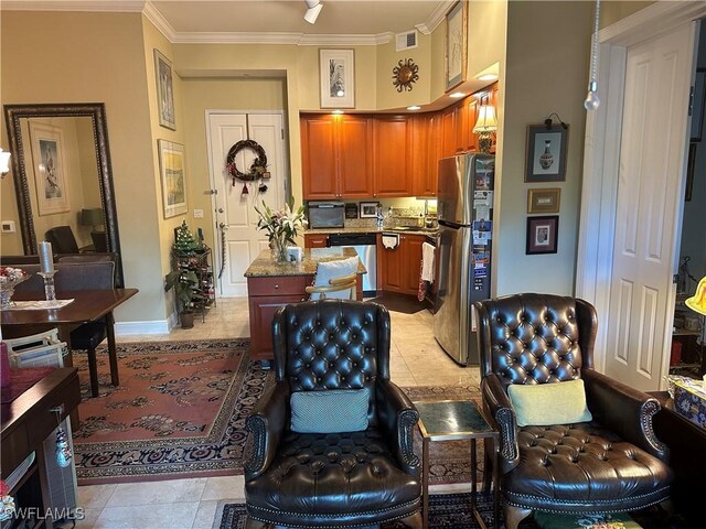 2825 Palm Beach Blvd Unit 118, Fort Myers, FL 33916 - kitchen featuring appliances with stainless steel finishes, a kitchen island, light tile patterned floors, crown molding, and brown cabinetry