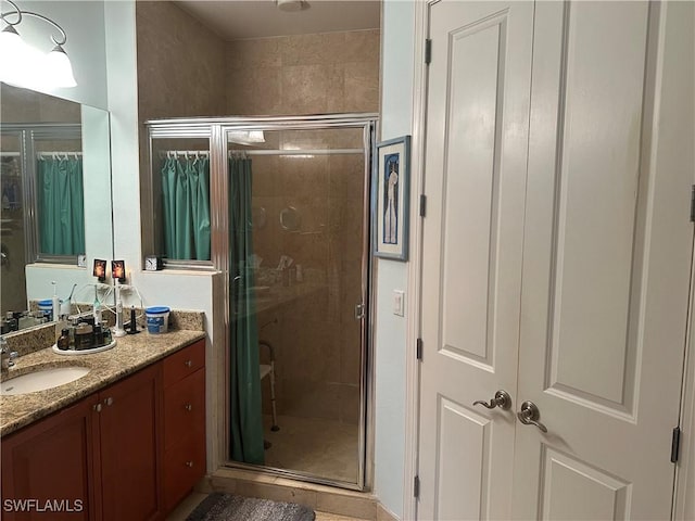 bathroom featuring vanity and a shower with door