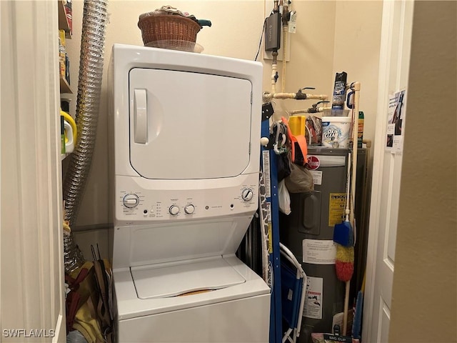 laundry area featuring stacked washer / dryer and water heater