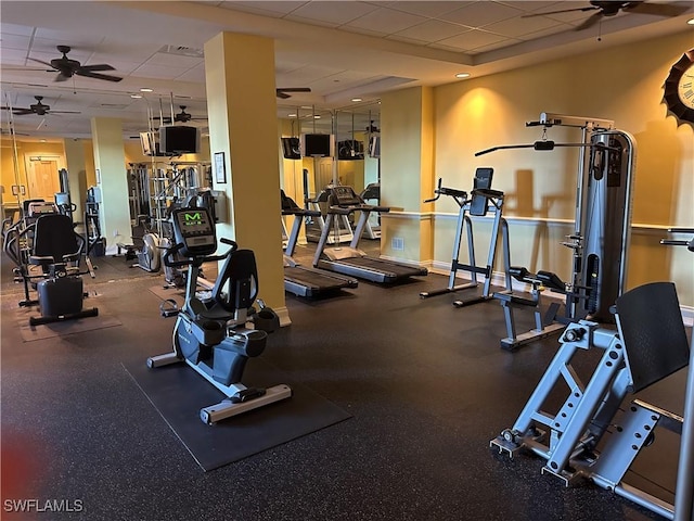 gym featuring ceiling fan and a drop ceiling