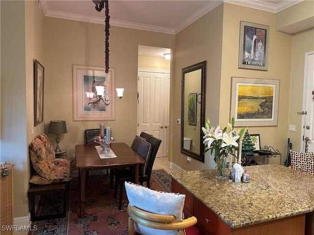 dining area with tile patterned floors, an inviting chandelier, and ornamental molding