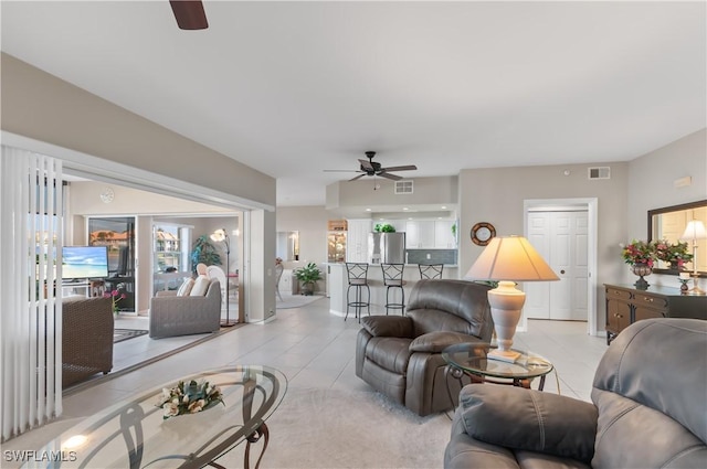 living room featuring ceiling fan and light tile patterned floors