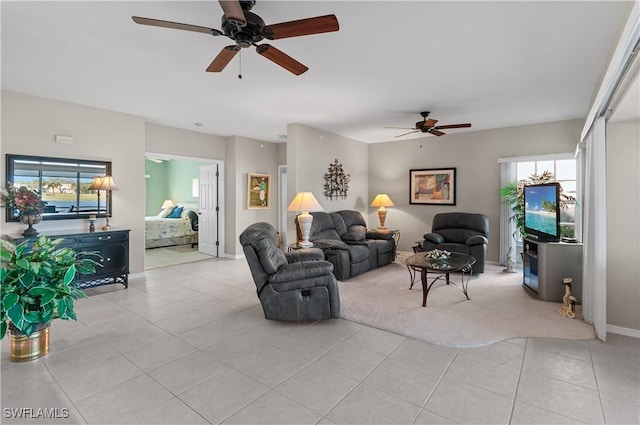 living room featuring ceiling fan and light tile patterned flooring