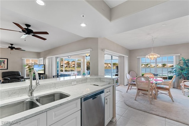 kitchen featuring stainless steel dishwasher, ceiling fan with notable chandelier, sink, decorative light fixtures, and white cabinetry