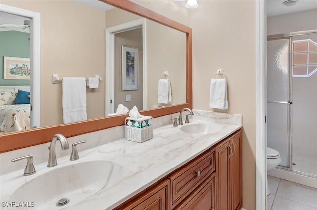 bathroom featuring tile patterned flooring, vanity, toilet, and walk in shower