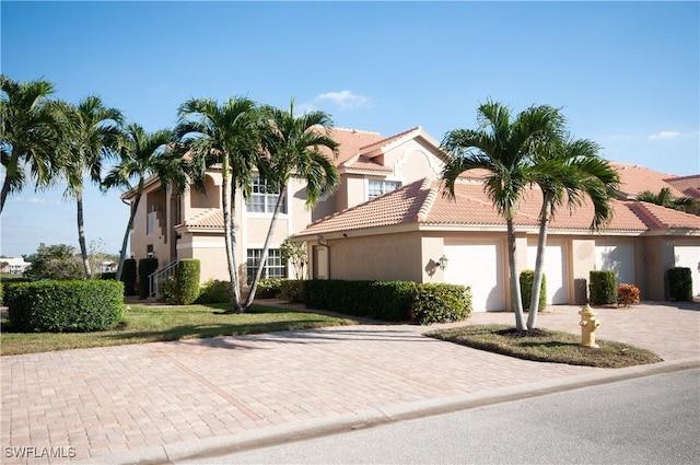 mediterranean / spanish-style house featuring a garage