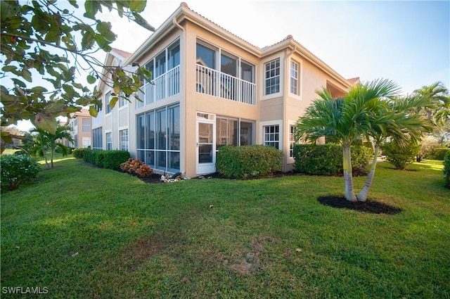 rear view of property featuring a yard