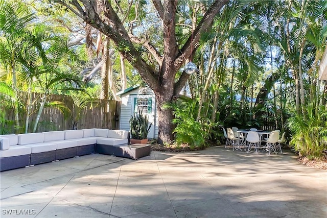 view of patio / terrace featuring an outdoor hangout area and a storage unit