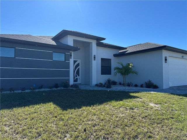 view of front facade with a garage and a front lawn