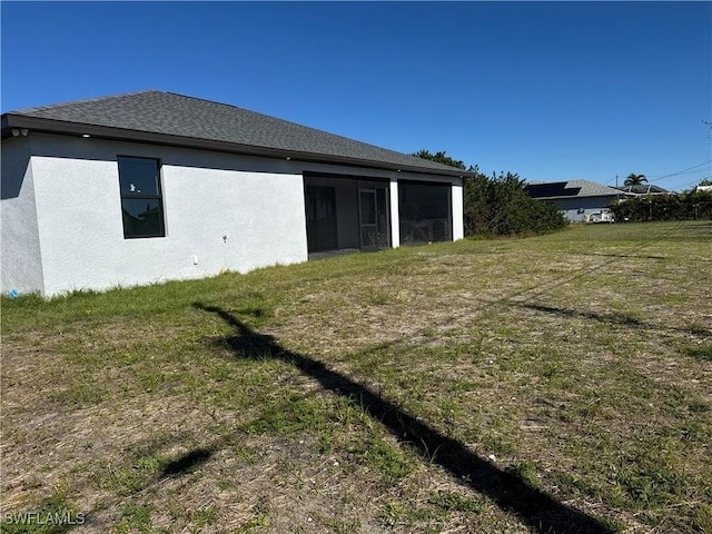 rear view of property featuring a yard