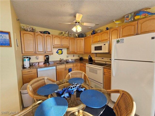 kitchen with sink, white appliances, a textured ceiling, and ceiling fan