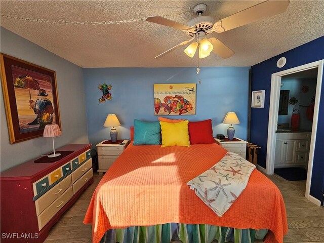 bedroom featuring ensuite bathroom, ceiling fan, and a textured ceiling