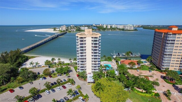 drone / aerial view featuring a water view and a view of the beach