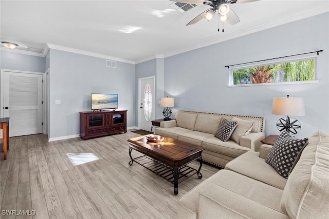 living room with ceiling fan, crown molding, and light hardwood / wood-style flooring