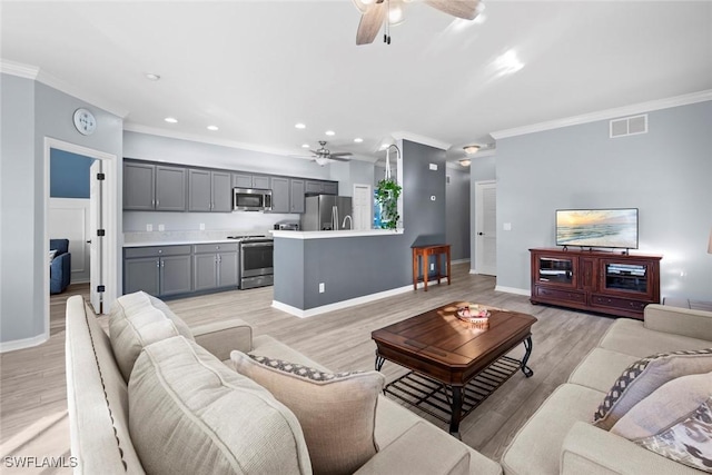 living room featuring ceiling fan, crown molding, and light hardwood / wood-style flooring