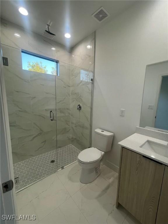 bathroom featuring vanity, toilet, and walk in shower