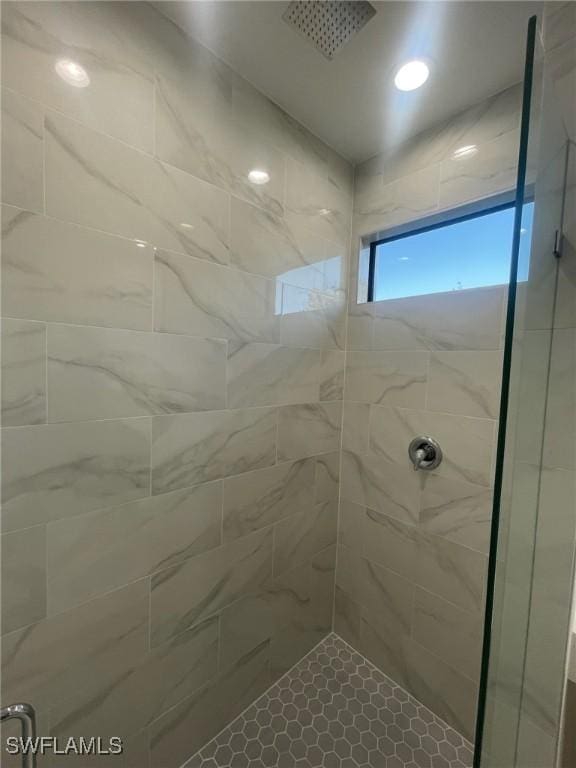 bathroom with a tile shower