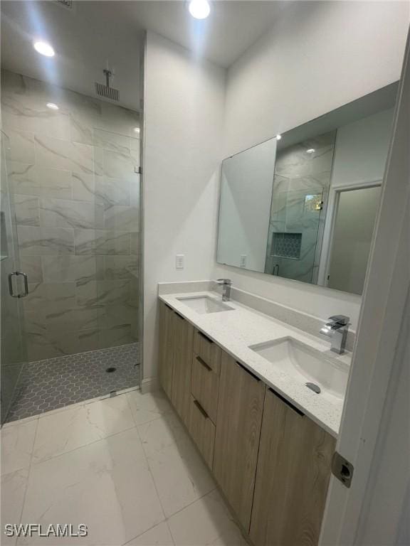 bathroom with vanity and a shower with door