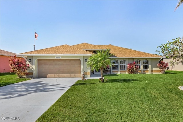 single story home with a front yard and a garage