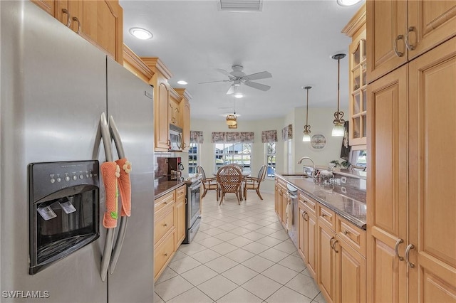 kitchen featuring ceiling fan, sink, decorative light fixtures, light tile patterned flooring, and appliances with stainless steel finishes