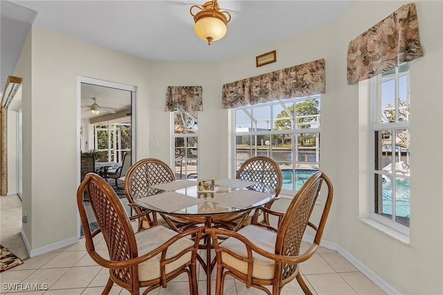 tiled dining area with ceiling fan