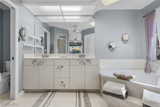 full bathroom featuring ceiling fan, tile patterned floors, toilet, vanity, and independent shower and bath