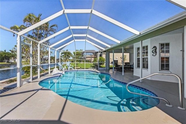 view of pool with a lanai, a water view, and a patio