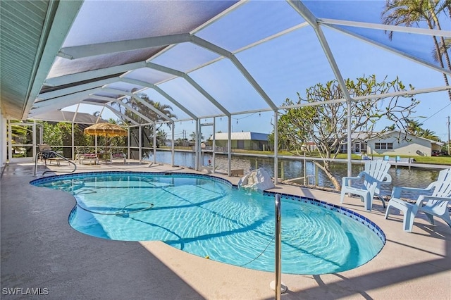 view of pool with a lanai, a patio area, and a water view