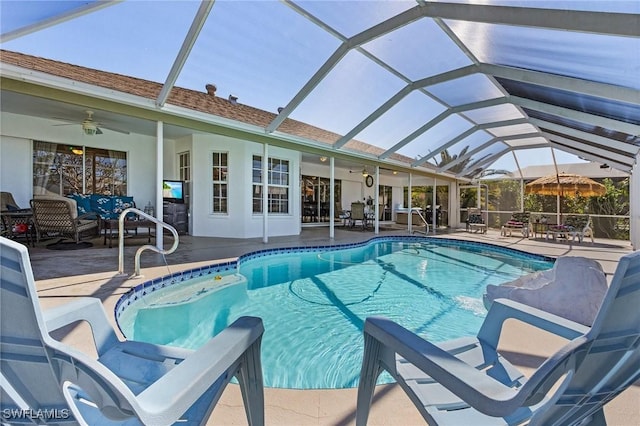 view of pool featuring an outdoor hangout area, glass enclosure, ceiling fan, and a patio area