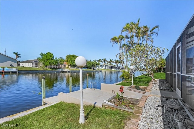 exterior space with a lanai and a water view