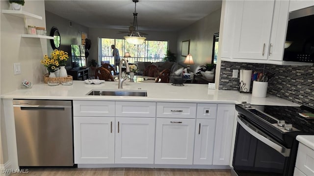 kitchen featuring white cabinets, decorative light fixtures, sink, electric range, and stainless steel dishwasher