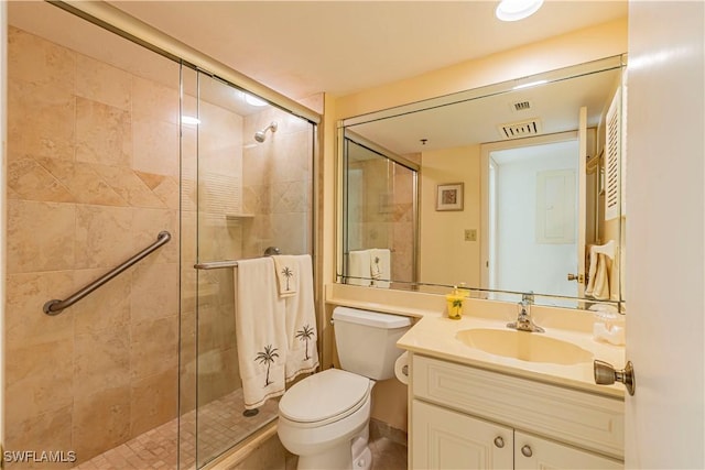 bathroom featuring vanity, an enclosed shower, and toilet