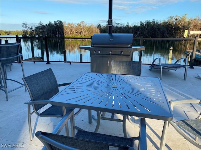 view of patio / terrace with a water view and a grill