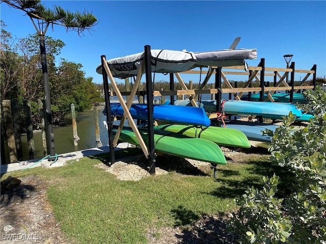 view of jungle gym with a water view and a boat dock