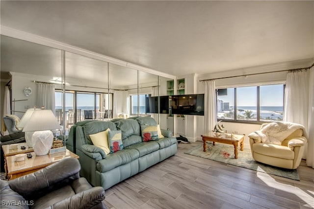 living room featuring light hardwood / wood-style flooring and ornamental molding