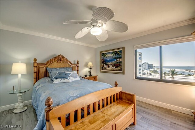 bedroom featuring ceiling fan, light hardwood / wood-style floors, and crown molding