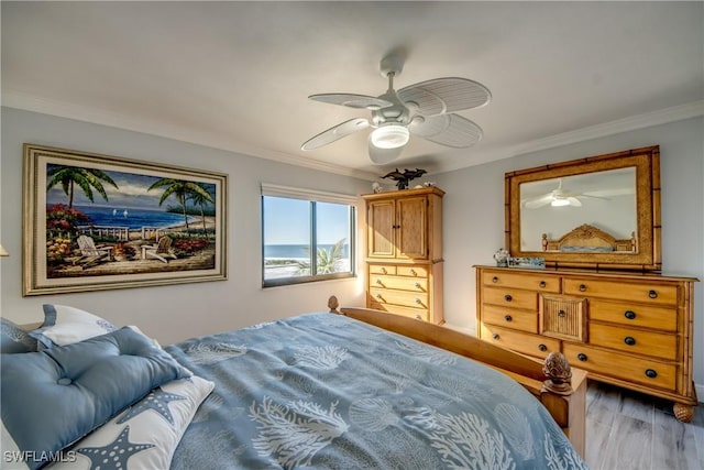 bedroom featuring ceiling fan, hardwood / wood-style floors, and ornamental molding