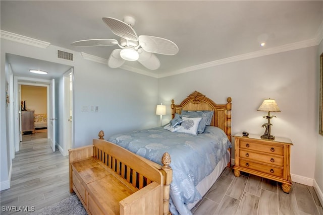 bedroom with ceiling fan, light wood-type flooring, and crown molding