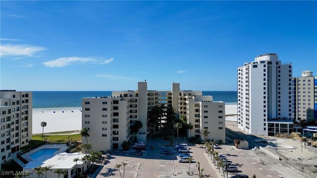 view of property featuring a water view and a beach view