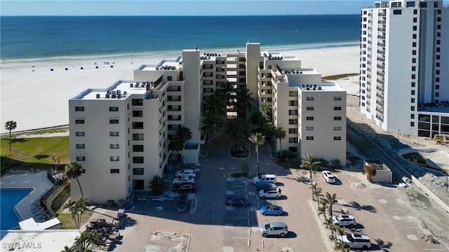 drone / aerial view with a water view and a view of the beach